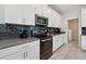 Modern kitchen featuring stainless steel appliances, gray countertops, and tiled flooring at 721 Drop Shot Dr, Davenport, FL 33896