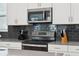 Close-up of stainless steel appliances and gray countertops in the kitchen at 721 Drop Shot Dr, Davenport, FL 33896