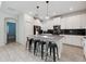 Bright kitchen featuring a gray island with bar seating and stainless steel appliances at 721 Drop Shot Dr, Davenport, FL 33896