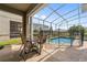 A screened-in patio area with a swimming pool, patio furniture, and outdoor space at 721 Drop Shot Dr, Davenport, FL 33896