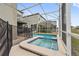 Screened-in pool and spa area with views of neighboring houses in a private backyard at 721 Drop Shot Dr, Davenport, FL 33896