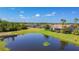 Scenic aerial view of waterfront property, showcasing lush landscaping and a picturesque lake in a residential community at 772 San Raphael St, Kissimmee, FL 34759