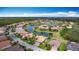 Stunning aerial view of a community surrounding a lake, showcasing well-maintained homes and lush greenery at 772 San Raphael St, Kissimmee, FL 34759