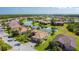 Scenic aerial shot of homes nestled within a community with a winding lake and lush landscaping at 772 San Raphael St, Kissimmee, FL 34759