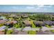 A beautiful residential community with well-maintained lawns, a winding lake, and mature trees captured from above at 772 San Raphael St, Kissimmee, FL 34759