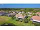 Expansive aerial view of a neighborhood featuring lush landscaping, mature trees, and well-maintained homes at 772 San Raphael St, Kissimmee, FL 34759