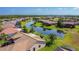 An aerial view of a residential community featuring lush landscaping and a scenic lake winding through the properties at 772 San Raphael St, Kissimmee, FL 34759