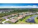 A wide aerial view of homes in a well-maintained community with ponds, green lawns, and mature trees at 772 San Raphael St, Kissimmee, FL 34759