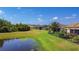 Enjoy the large backyard with water views of this charming single-story home featuring a screened lanai at 772 San Raphael St, Kissimmee, FL 34759