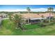 Aerial view of backyard with screened lanai, lush landscaping, and community at 772 San Raphael St, Kissimmee, FL 34759