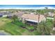 A beautiful backyard with green grass, palm trees, a screened-in patio, and a black metal fence for privacy at 772 San Raphael St, Kissimmee, FL 34759