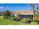 Charming single-story home features a screened lanai, beautifully landscaped yard with black metal fence and palm trees at 772 San Raphael St, Kissimmee, FL 34759