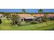 Charming single-story home features a screened lanai, beautifully landscaped yard with black metal fence and palm trees at 772 San Raphael St, Kissimmee, FL 34759