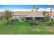 Aerial view of backyard with screened lanai, lush landscaping, and tiled roof at 772 San Raphael St, Kissimmee, FL 34759