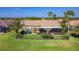 Charming single-story home features a screened lanai, beautifully landscaped yard with black metal fence and palm trees at 772 San Raphael St, Kissimmee, FL 34759