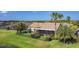 Charming single-story home features a screened lanai, beautifully landscaped yard with black metal fence and palm trees at 772 San Raphael St, Kissimmee, FL 34759