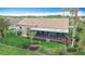 Aerial view showcasing backyard, screened lanai, tile roof, and lush landscaping at 772 San Raphael St, Kissimmee, FL 34759