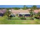 Charming single-story home features a screened lanai, beautifully landscaped yard with black metal fence and palm trees at 772 San Raphael St, Kissimmee, FL 34759