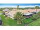 Aerial view of backyard with a screened lanai, tile roof, and fenced yard at 772 San Raphael St, Kissimmee, FL 34759