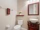 Powder room with dark wood vanity, granite counter and above counter bowl sink at 772 San Raphael St, Kissimmee, FL 34759