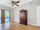 Bedroom featuring laminate floors, ceiling fan and sliding door to outdoor patio at 772 San Raphael St, Kissimmee, FL 34759