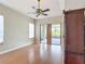 Main bedroom with laminate floors, ceiling fan, and sliding doors to patio at 772 San Raphael St, Kissimmee, FL 34759