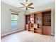 Bedroom features a ceiling fan, built in wood bookshelf and a window providing natural light at 772 San Raphael St, Kissimmee, FL 34759