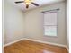 Neutral bedroom with laminate flooring, ceiling fan and window at 772 San Raphael St, Kissimmee, FL 34759