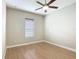 Bedroom with wood flooring, ceiling fan, and a large window at 772 San Raphael St, Kissimmee, FL 34759