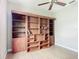 Bedroom featuring a large built in, wooden bookshelf, ceiling fan, and wood laminate flooring at 772 San Raphael St, Kissimmee, FL 34759
