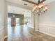 Open dining room showcasing tiled flooring, chandelier, and seamless flow to other living spaces at 772 San Raphael St, Kissimmee, FL 34759