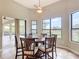 Bright breakfast nook with tiled floor, large windows offering water views, and a ceiling fan at 772 San Raphael St, Kissimmee, FL 34759