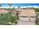 Beautiful home featuring a well-manicured lawn, tropical landscaping, and a paver driveway leading to a two-car garage at 772 San Raphael St, Kissimmee, FL 34759