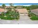 Beautiful home featuring a well-manicured lawn, tropical landscaping, and a paver driveway leading to a two-car garage at 772 San Raphael St, Kissimmee, FL 34759