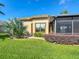Exterior view highlighting the home's screened-in patio and landscaped backyard at 772 San Raphael St, Kissimmee, FL 34759