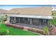 Back exterior showcasing the screened-in lanai, tile roof and landscaped backyard at 772 San Raphael St, Kissimmee, FL 34759