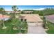 Beautiful home featuring a well-manicured lawn, tropical landscaping, and a paver driveway leading to a two-car garage at 772 San Raphael St, Kissimmee, FL 34759