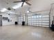 Spacious three-car garage with painted floor and ceiling fans at 772 San Raphael St, Kissimmee, FL 34759