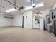 Three-car garage with storage and ceiling fans at 772 San Raphael St, Kissimmee, FL 34759
