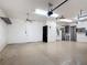 Large three-car garage with neutral colored walls and painted floor at 772 San Raphael St, Kissimmee, FL 34759