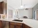 Kitchen featuring an undermount sink, granite countertop, stainless steel appliances, and wood cabinets at 772 San Raphael St, Kissimmee, FL 34759