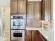 Kitchen with stainless steel oven, white countertop and wood cabinets at 772 San Raphael St, Kissimmee, FL 34759