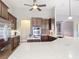 A kitchen featuring granite countertops, a large island, stainless steel appliances, and wood cabinets at 772 San Raphael St, Kissimmee, FL 34759