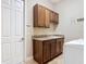 Laundry room with utility sink and upper cabinets at 772 San Raphael St, Kissimmee, FL 34759