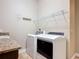 Laundry room with modern appliances and a granite-topped counter at 772 San Raphael St, Kissimmee, FL 34759