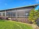 A covered and screened lanai provides an outdoor entertaining space overlooking the green backyard at 772 San Raphael St, Kissimmee, FL 34759