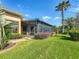 View of screened lanai off the back of the home showing an expansive patio with green surroundings at 772 San Raphael St, Kissimmee, FL 34759