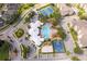 Overhead of a community pool, clubhouse, tennis court, and lush landscaping, offering a resort-like atmosphere at 8217 Fan Palm Way, Kissimmee, FL 34747