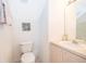 Cozy bathroom featuring a toilet, sink with vanity, and decorative wall art at 8217 Fan Palm Way, Kissimmee, FL 34747