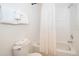 All-white bathroom with shower/tub combo, white toilet, and bright overhead lighting at 8217 Fan Palm Way, Kissimmee, FL 34747